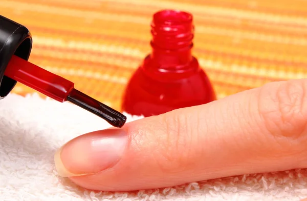 Nail polish applied to the hand of woman — Stock Photo, Image