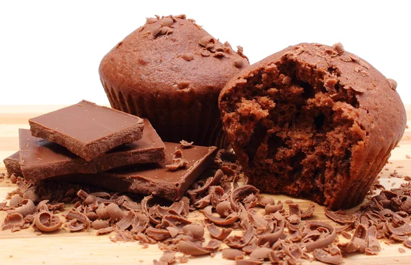 Fresh baked muffins, grated and portion of chocolate — Stock Photo, Image