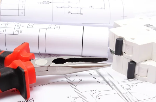 Rolled electrical diagrams, electric fuse and work tools on construction drawing of house — Stock Photo, Image