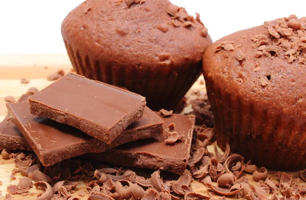 Fresh baked muffins, grated and portion of chocolate — Stock Photo, Image