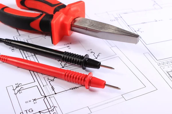 Cables of multimeter and work tool on construction drawing — Stock Photo, Image