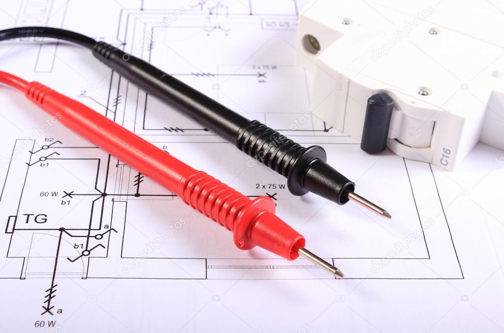 Cables of multimeter and electric fuse on construction drawing