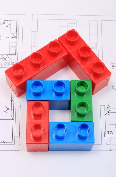 House of colorful building blocks on drawing of home — Stock Photo, Image