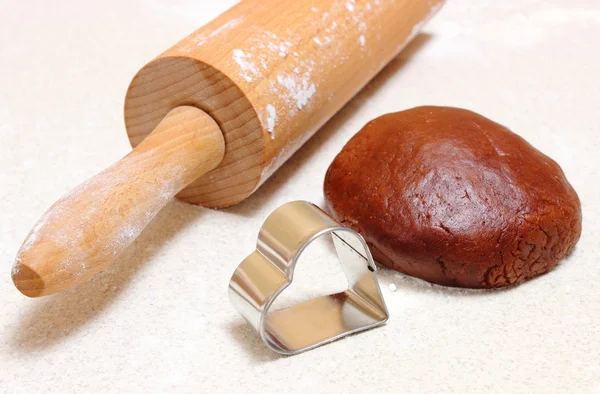 Gingerbread dough for Christmas cookies, cookie cutters and rolling pin — Stock Photo, Image