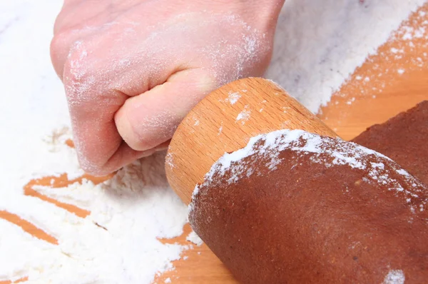 Hand with rolling pin kneading dough for gingerbread — Stock Photo, Image