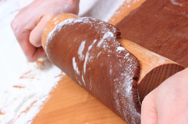 Hand with rolling pin kneading dough for gingerbread — Stock Photo, Image