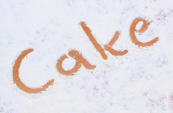 Word cake written in flour — Stock Photo, Image