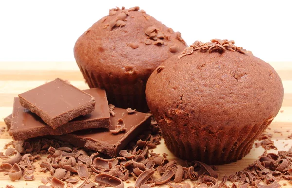 Fresh baked muffins, grated and portion of chocolate — Stock Photo, Image