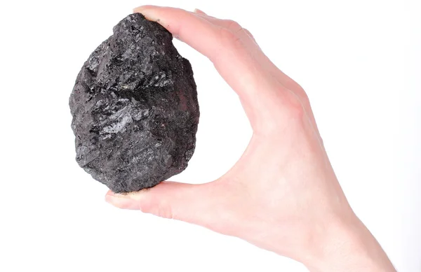 Woman hand holding coal lump on white background — Stock Photo, Image