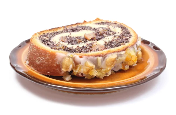 Piece of poppy seed cake lying on brown plate — Stock Photo, Image