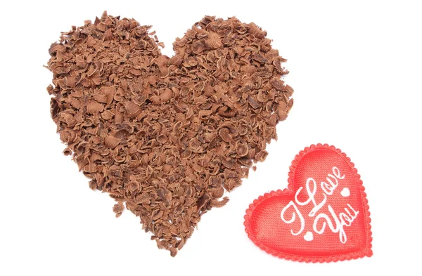 Heart shaped grated chocolate on white background — Stock Photo, Image