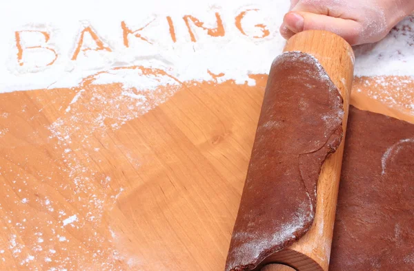 Hand with rolling pin kneading dough for gingerbread — Stock Photo, Image