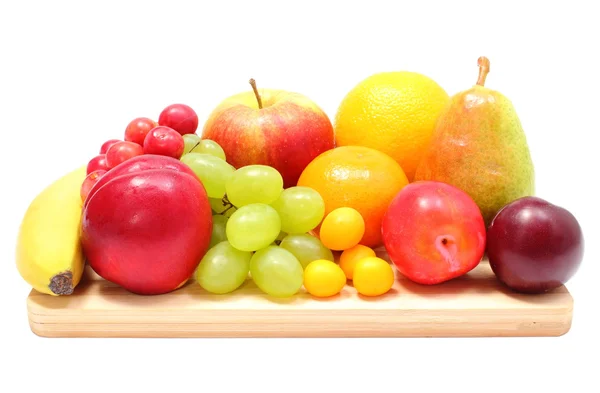 Fresh ripe fruits on wooden cutting board — Stock Photo, Image