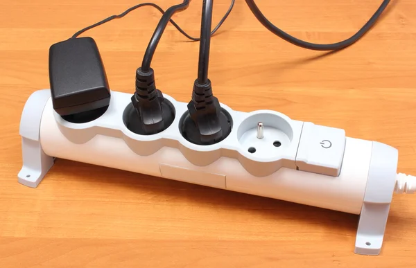 Electrical cords connected to power strip, concept of energy saving — Stock Photo, Image