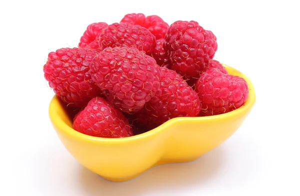 Fresh raspberries in yellow bowl on white background — Stock Photo, Image