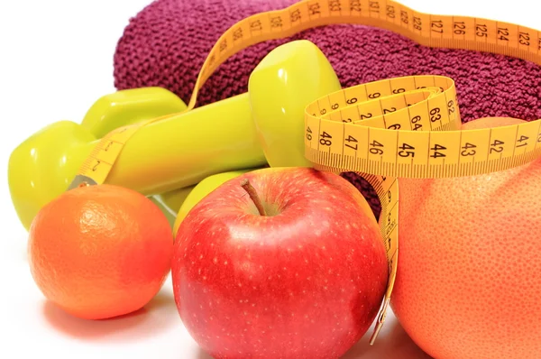 Fruits, tape measure, green dumbbells and towel on white — Stock Photo, Image
