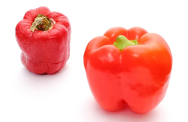 Fresh and wrinkled peppers on white background — Stock Photo, Image