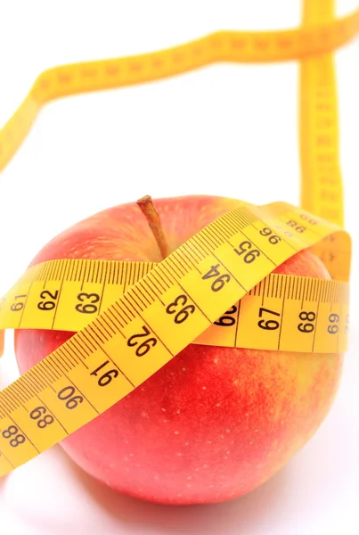 Fresh apple and tape measure on white background — Stock Photo, Image