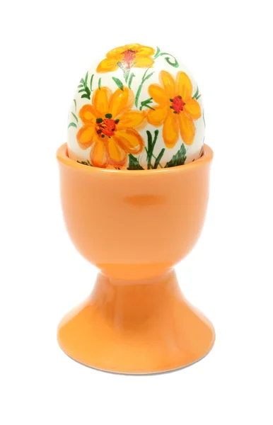 Colorido huevo de Pascua en taza de naranja. Aislado sobre fondo blanco — Foto de Stock