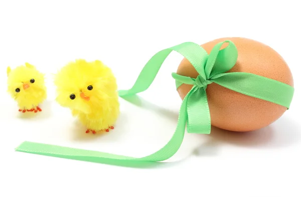 Easter chickens and egg with green ribbon. White background — Stock Photo, Image