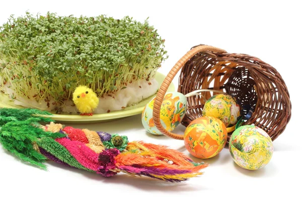 Easter palm and eggs in overturned wicker basket and watercress — Stock Photo, Image