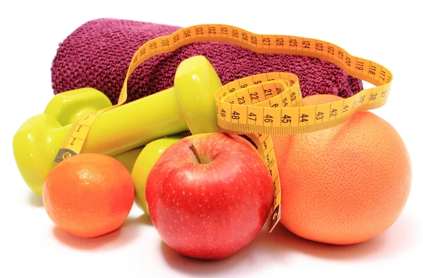 Fruits, tape measure, green dumbbells and towel on white — Stock Photo, Image