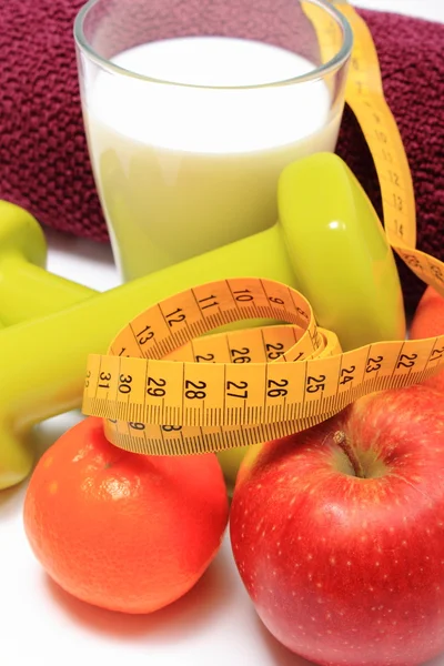 Früchte, Klebeband, Milch, grüne Hanteln und lila Handtuch auf weiß — Stockfoto