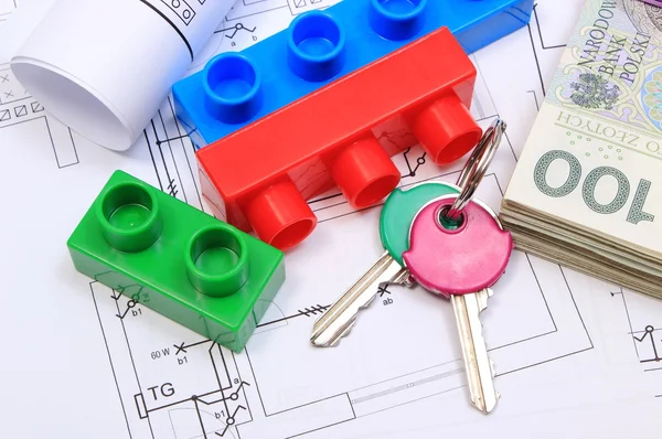 Banknotes, keys, building blocks and electrical diagrams on drawing of house — Stock Photo, Image