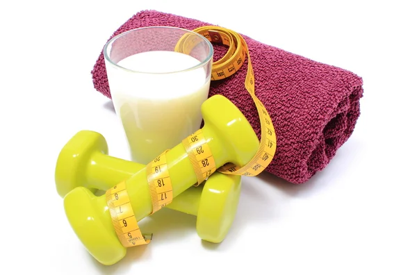 Dumbbells, towel for using in fitness and measure tape with glass of milk — Stock Photo, Image