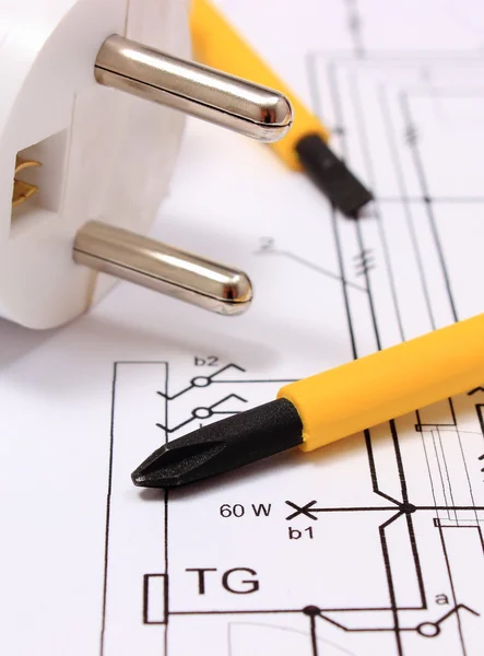 Screwdriver and electric plug on construction drawing — Stock Photo, Image