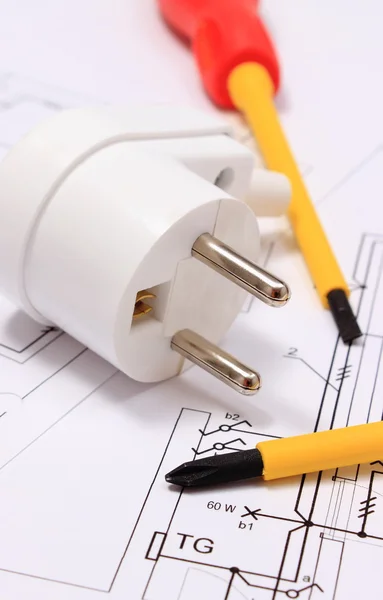 Screwdriver and electric plug on construction drawing — Stock Photo, Image
