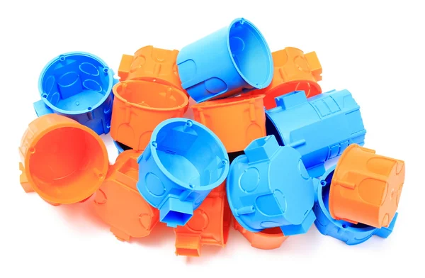 Un mucchio di scatole elettriche arancioni e blu su sfondo bianco — Foto Stock
