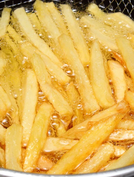 French fries fried in oil — Stock Photo, Image