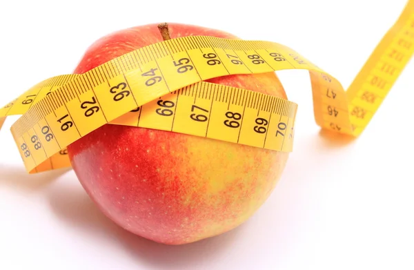 Fresh apple and tape measure on white background Royalty Free Stock Photos