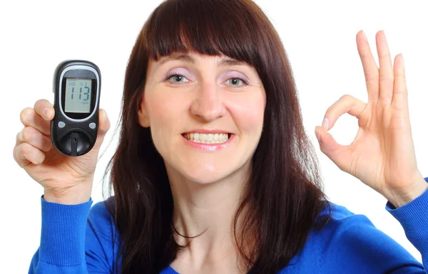 Donna sorridente con misuratore di glucosio su sfondo bianco — Foto Stock