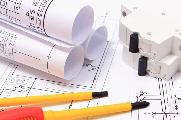 Screwdriver, rolls of diagrams and electric fuse on construction drawing — Stock Photo, Image