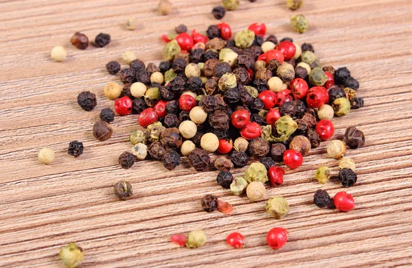 Heap of fresh colored pepper on wooden background — Stock Photo, Image