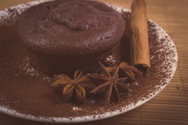 Vintage photo of chocolate muffins, star anise and cinnamon — Stockfoto