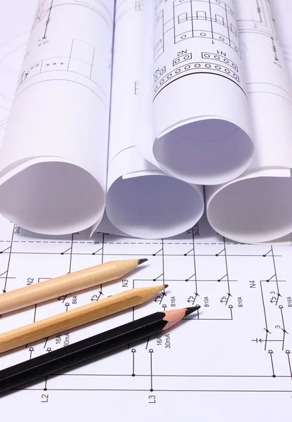 Rolls of electrical diagrams and pencils