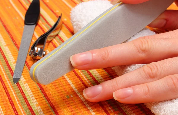 Woman polishing fingernails with nail file — Stock Photo, Image