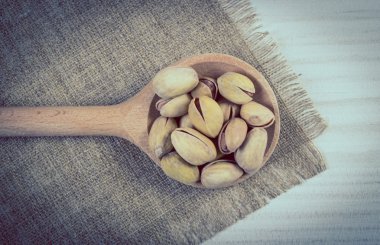 Vintage Fotoğraf, Beyaz ahşap masa, sağlıklı kaşık ile fıstık fındık yemek