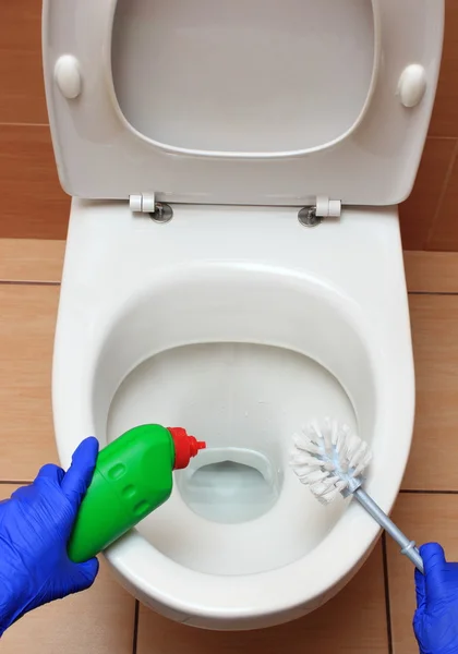 Hand of woman in blue glove cleaning toilet bowl — Stock Photo, Image