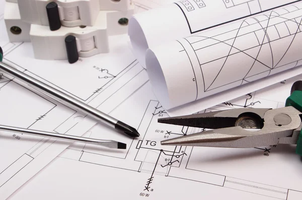 Work tools, electric fuse and rolls of diagrams on construction drawing of house — Stock Photo, Image