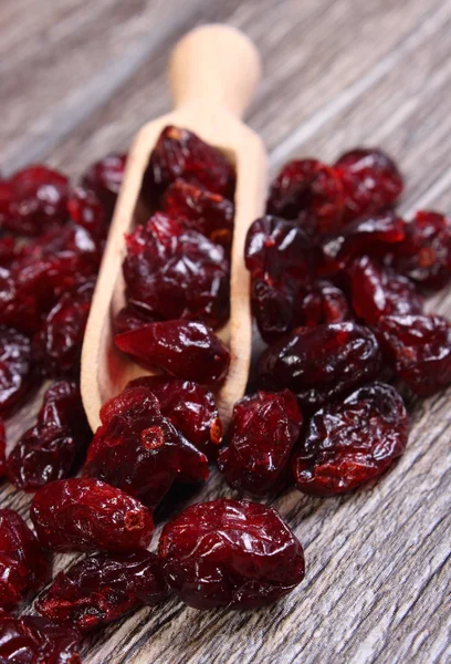 Heap of red cranberries with spoon on wooden table — Stock Photo, Image