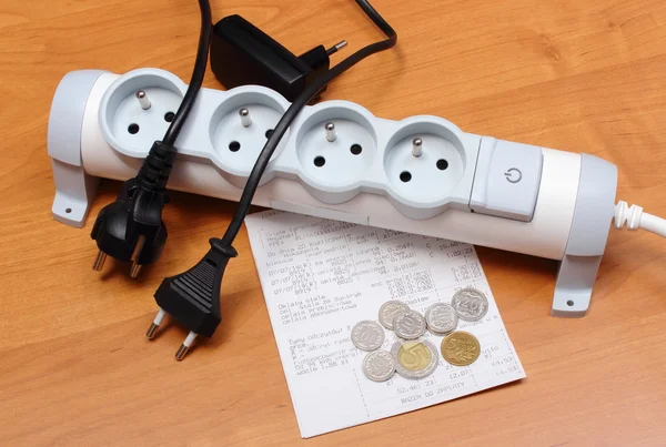 Electrical cords disconnected from power strip, electricity bill — Stock Photo, Image