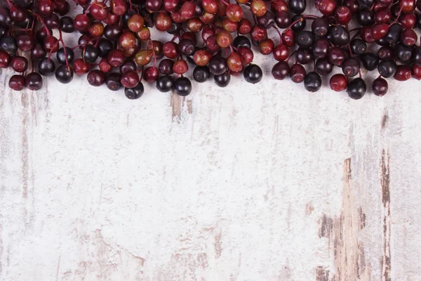 Autumn fresh elderberry and copy space for text on old wooden background — Stock Photo, Image