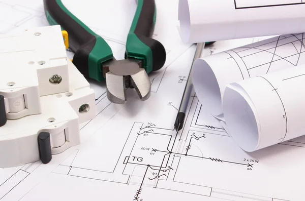 Work tools, electric fuse and rolls of diagrams on construction drawing of house — Stock Photo, Image