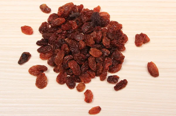 Brown raisins on wooden table, healthy eating — Stock Photo, Image