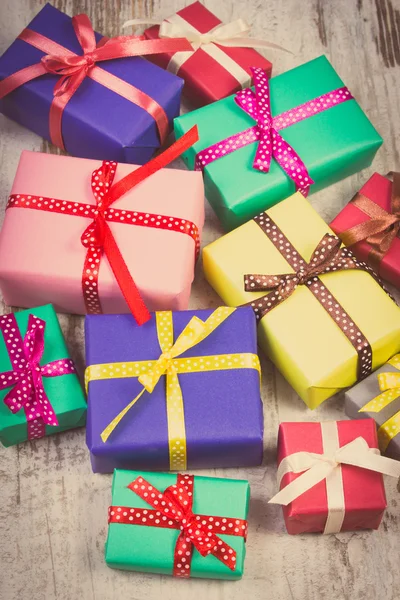 Vintage photo, Wrapped colorful gifts for Christmas or other celebration on old white plank — ストック写真