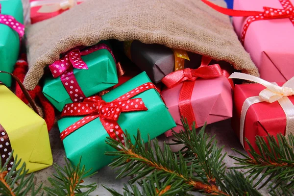 Wrapped gifts in jute bag for Christmas or other celebration — Stock Photo, Image